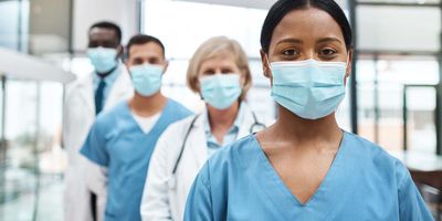Clinical laboratory experts wearing surgical masks.